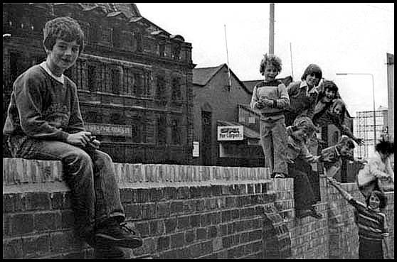 boy and group of kids on a wall